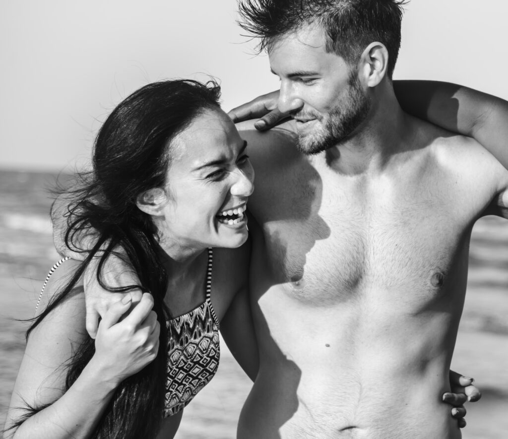 Couple embracing on a beach in black and white