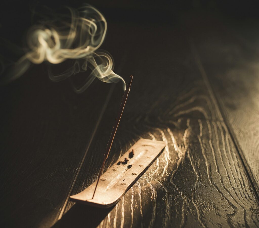 Soft smoke rising from incense, like a fragrance unfolding over time