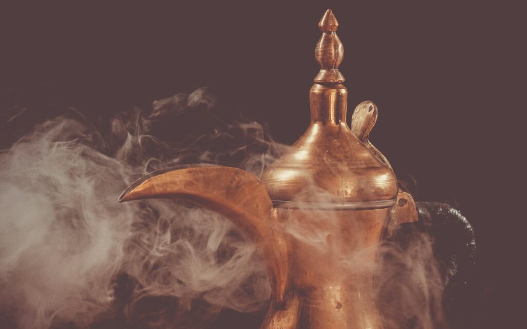 A brass vessel wrapped in drifting smoke on a dark background