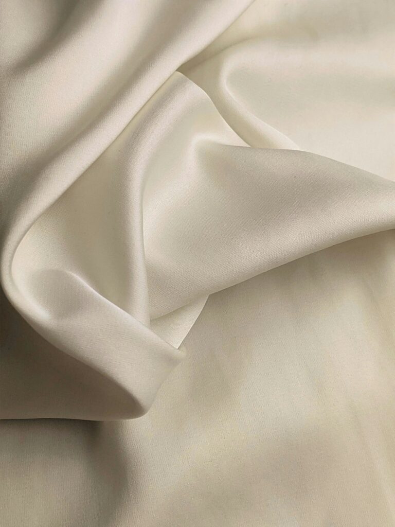 Draped silk fabric, as fabric holds scent for longer than skin